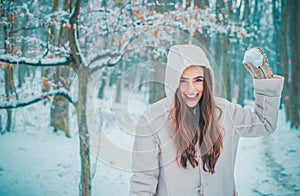 Winter portrait of young beautiful brunette woman in snow Garden. People in snow. Woman winter portrait.