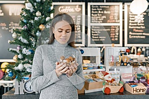 Winter portrait of young beautiful woman with bowl of hazelnuts and walnuts