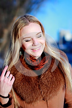 Winter portrait. Young, beautiful woman in winter dress, close e