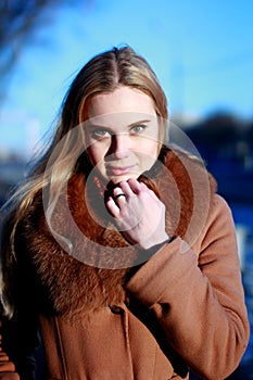 Winter portrait. Young, beautiful woman in winter dress looking