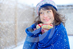 Winter portrait of a young woman. Beauty Joyous Model Girl touching her face skin and laughing, having fun in the winter park. Bea