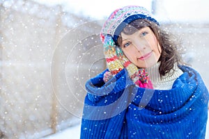 Winter portrait of a young woman. Beauty Joyous Model Girl touching her face skin and laughing, having fun in the winter park. Bea