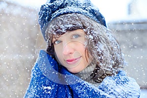 Winter portrait of a young woman. Beauty Joyous Model Girl touching her face skin and laughing, having fun in the winter park. Bea