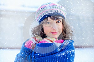 Winter portrait of a young woman. Beauty Joyous Model Girl touching her face skin and laughing, having fun in the winter park. Bea