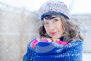 Winter portrait of a young woman. Beauty Joyous Model Girl touching her face skin and laughing, having fun in the winter park. Bea