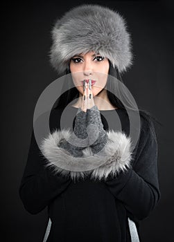 Winter portrait of a young woman in a grey hat and gloves