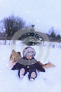 Winter portrtrait of baby and dog