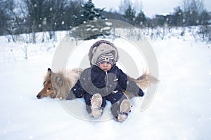 Winter portrtrait of baby and dog