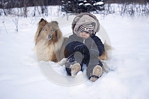 Winter portrtrait of baby and dog