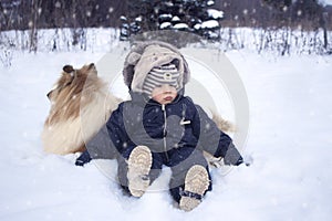 Winter portrtrait of baby and dog