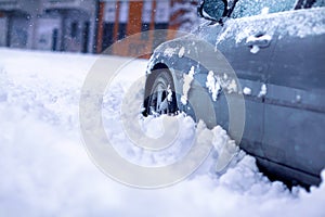 Winter problems of car drivers. Car on a snowy road. car stuck in snow