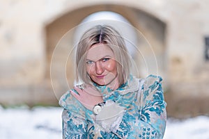 Winter queen in an abandoned castle. A beautiful woman in a winter suit