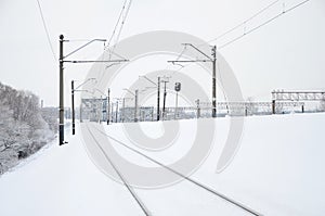 Winter railway landscape, Railway tracks in the snow-covered industrial country