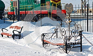 Winter on the railway. a snow-covered bench with the inscription
