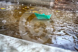 Winter rains in Israel, floods. A stream of rainwater carries a Origami Ship