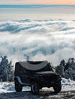 Winter ravel concept with 4x4 car. Offroad winter car. Adventure travel. Off-road travel on snow mountain road.