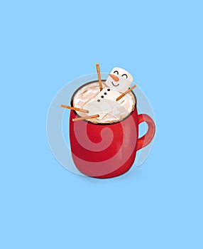 Winter red mug with snowman marshmallow and hot chocolate on a blue background. Illustration of a winter dessert drink