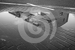 Winter Reflection of a Building in a Puddle