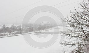 Winter river on a background of a snowy landscape, blizzard, background. Beautiful nature