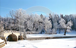 Winter river with old bridge