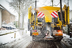 Winter road maintenance truck spreading salt and sand