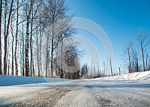 Winter road in the russian forest in a clear sunny day