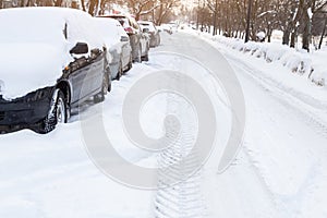 Winter road in the snow. Cars covered snow