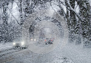Winter road through snow-covered car glass, snowfall