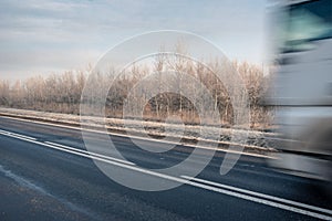 A winter road with a speeding truck