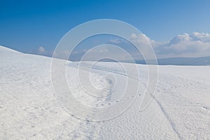 Winter road under blue sky