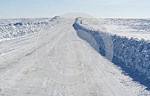 Winter road under blue sky