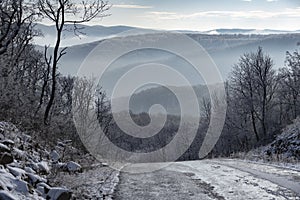 Winter road uphill in the mountains