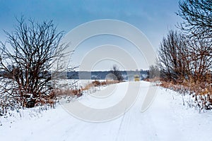 Winter road on which the bus rides. Winter landscape with road and trees_