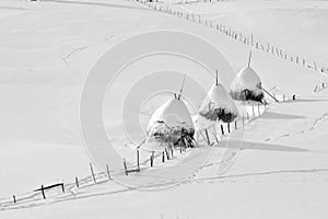 Winter in Romania, haystack in Transylvania village