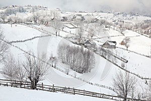 Winter in a Romanian mountain village with the Carpathians