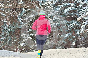 Winter running in park: happy woman runner jogging in snow, outdoor sport and fitness