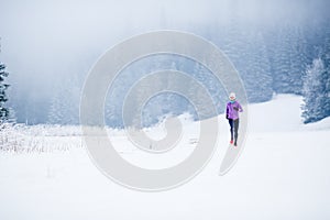 Winter running woman, jogging inspiration and motivation