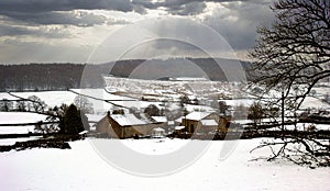 Winter rural farm scene with snow covered landscape