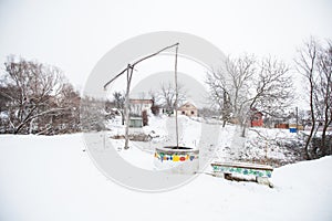 Winter rural landscape , old traditional water well