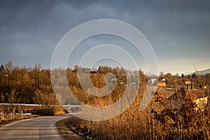 Winter rural scene at sunset with bits of snow