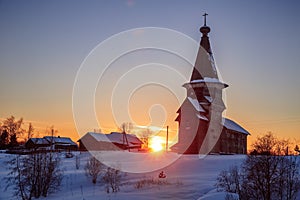 Sunset landscape with old wooden church