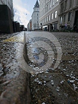 Winter's Chill: A Cobblestone Street in the Aftermath of a Hailstorm