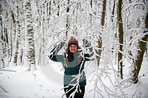 Winter's Embrace: Woman Surrounded by Snow-Covered Trees