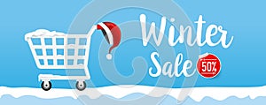 Winter sale calligraphy text with shpping cart and santa hat 001 photo