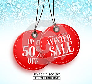 Winter sale vector banner with two red sale tag hanging in white snow background