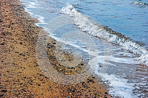 A winter scene of the bay and Sandy shoreline and waves at ebbtide photo