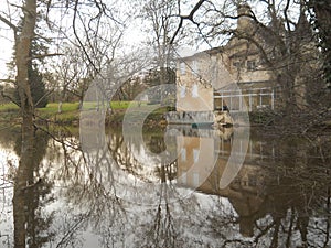 Winter scene building reflected on a lake