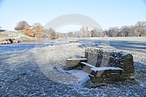 Winter scene, dry stone wall, river, trees, frost, snow.