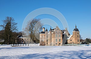 Winter scene with dutch historic architecture. Medieval castle in snow landscape with moat and towers, rural nature. Culture trave