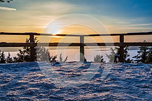 Winter Scene with Golden Sunset over Frozen Lake